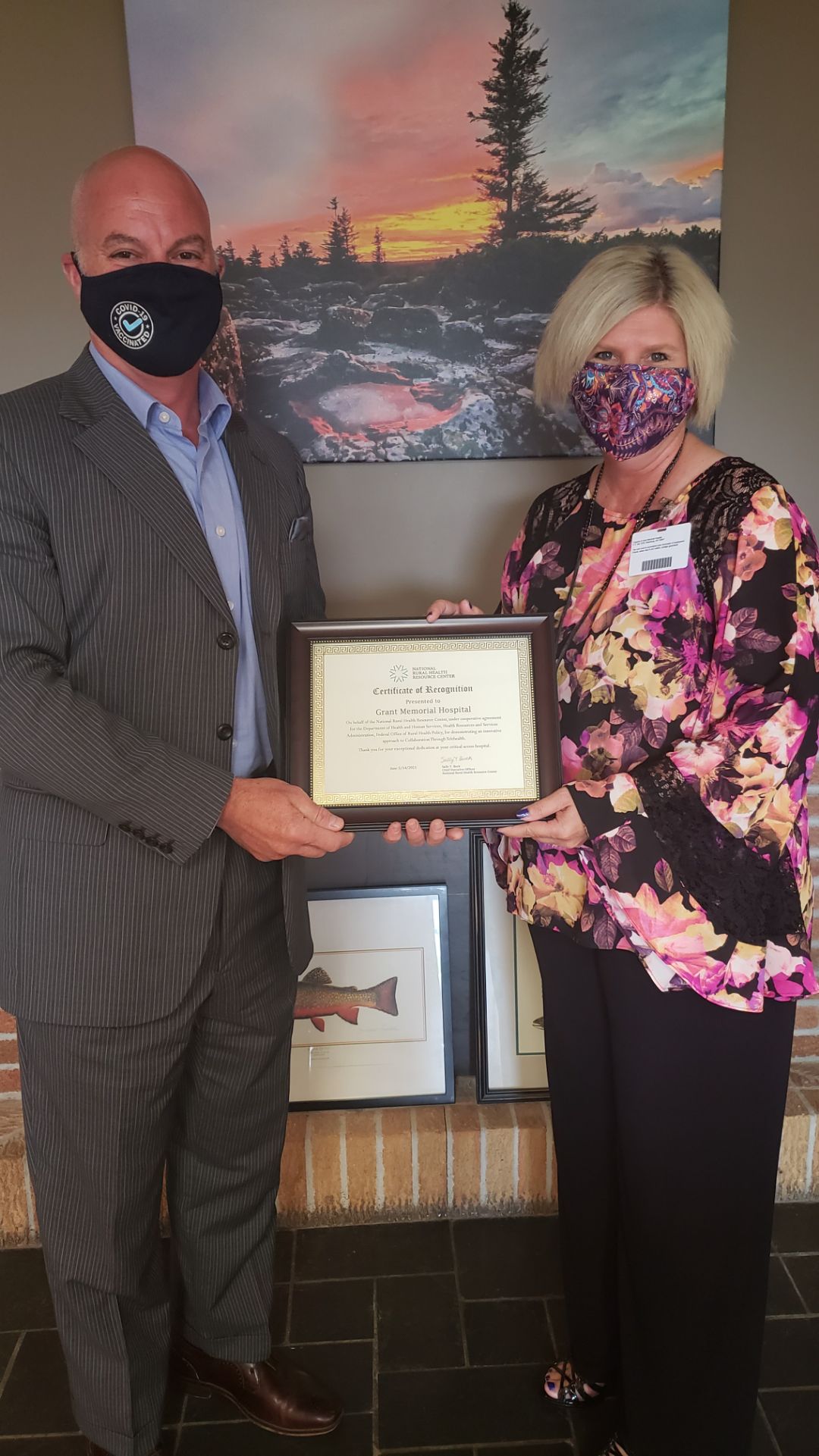 Bob Milvet, CEO, Grant Memorial Hospital accepting recognition certificate from Lisa Lewis, Hospital Programs Manager, West Virginia State Office of Rural Health