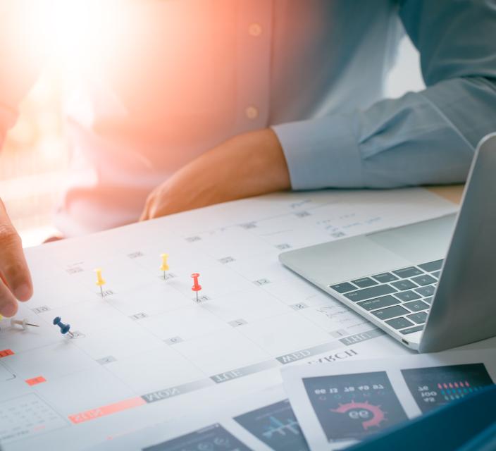 man looking at calendar of events