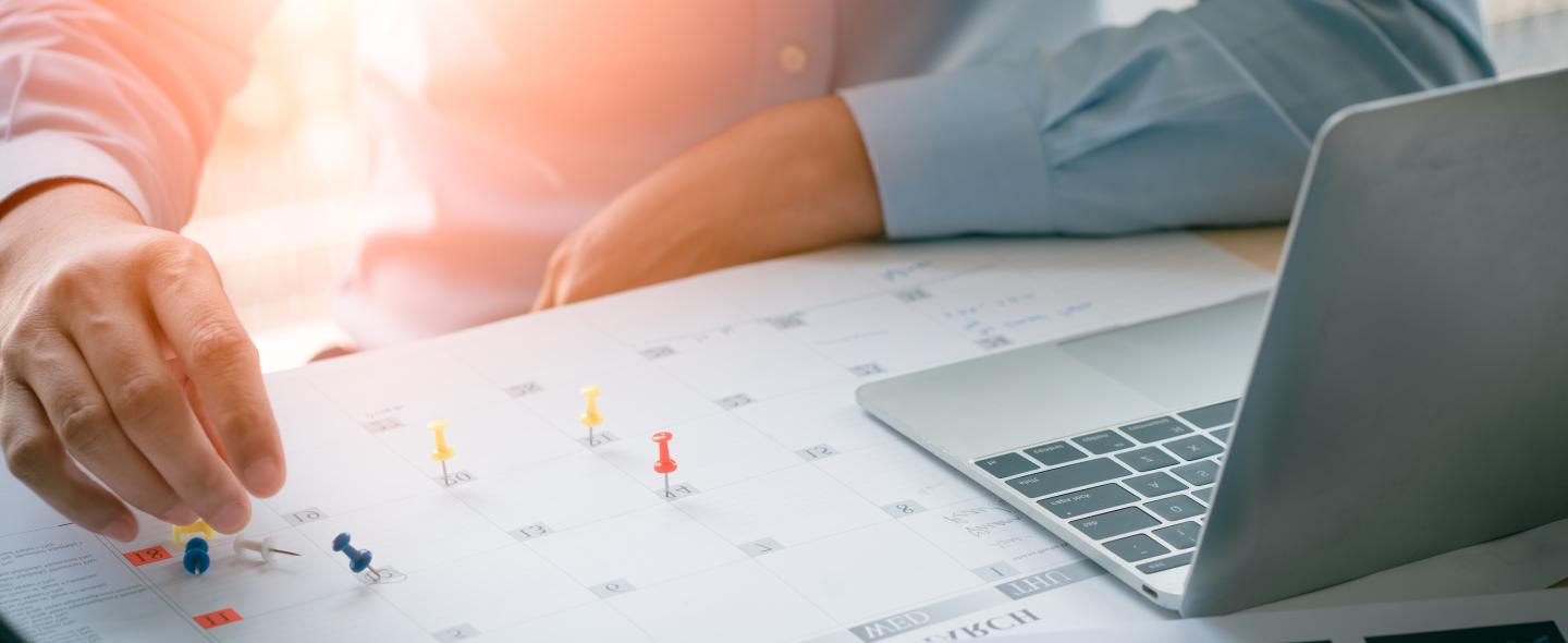 man looking at calendar of events