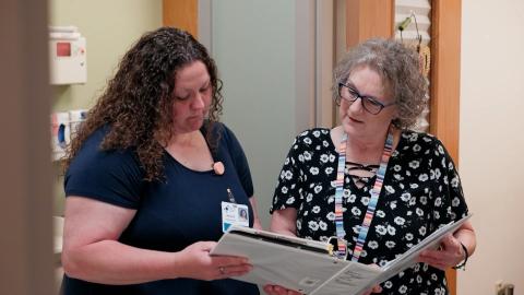 staff looking at binder