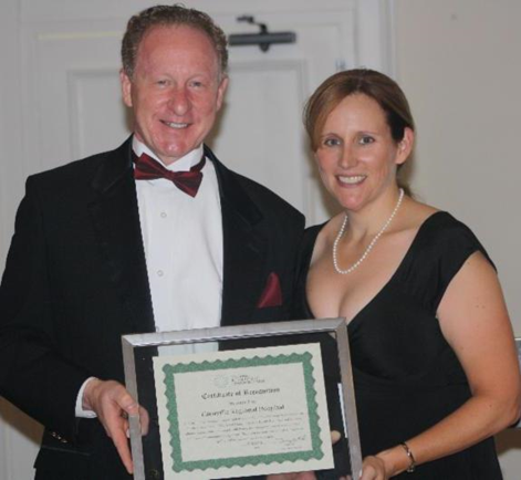 Steven L. Kelley, FACHE, Ellenville Regional Hospital President and CEO receiving award from Karen Madden, State Office of Rural Health Director, New York