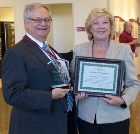 Harry Wolin, CEO, Mason District Hospital, receiving award from Pat Schou, Illinois Flex Program