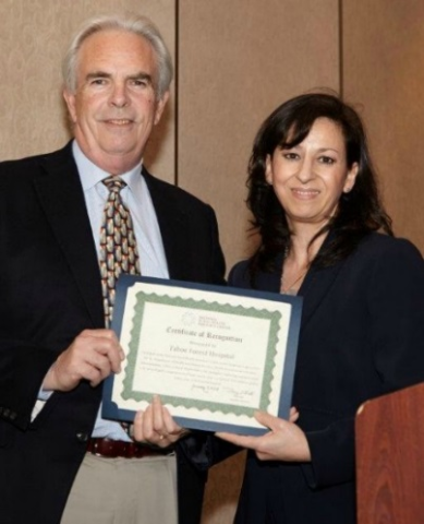 Hospital CEO Bob Schapper receiving award from Angelica Perez, State Flex Coordinator, California